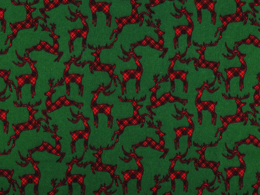 Bild mit weihnachtlichem Baumwollflanell mit Rentieren auf Grün – online erhältlich bei Šarlotes audumi
