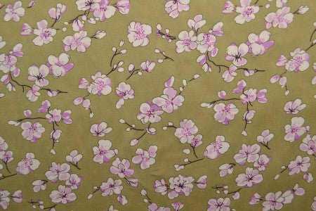 Attache avec tissu 100 % viscose - fleurs de cerisier sur fond vert pistache 100 g/m² – disponible chez Charlotte's fabrics