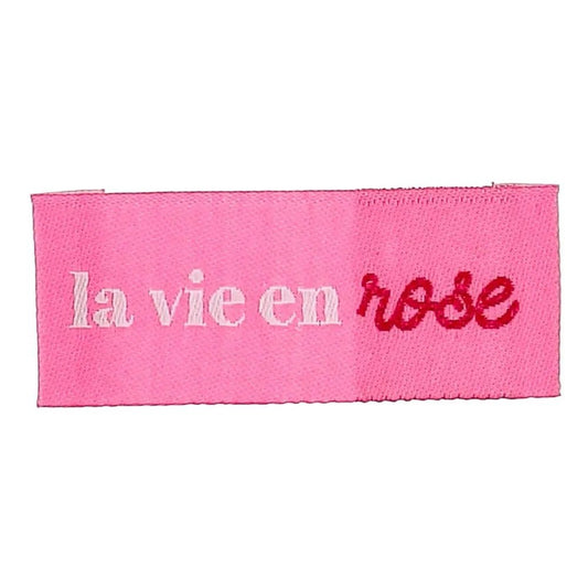 Bild von Bohin-Einnähetiketten für Kleidung mit dem Motiv „La vie en rose – das Leben durch die rosarote Brille sehen“, 2 × 5 cm, 4 Stück – online bei Šarlotes audumi erhältlich