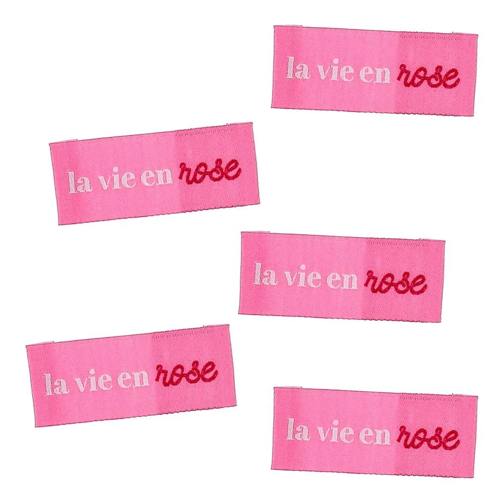 Bild von Bohin-Einnähetiketten für Kleidung mit dem Motiv „La vie en rose – das Leben durch die rosarote Brille sehen“, 2 × 5 cm, 4 Stück – online bei Šarlotes audumi erhältlich