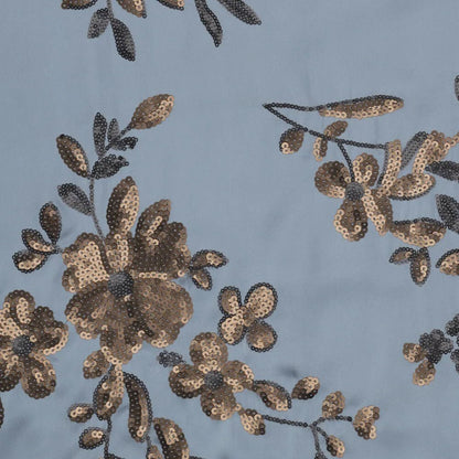 Image d’un tissu satin extensible avec broderie florale et paillettes en bleu, noir et doré – disponible en ligne chez Charlotte’s Fabrics