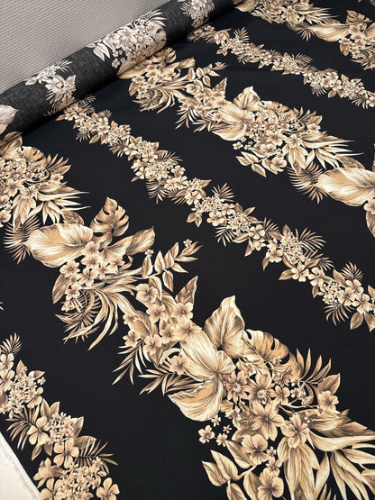 Image of Italian cotton fabric with a tropical floral pattern on a black background - available online at Šarlotes audumi