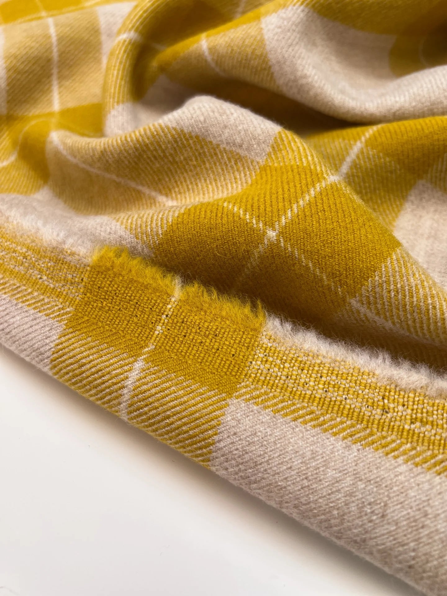 Image of Italian wool and alpaca fabric in a plaid pattern in mustard yellow tones – available online at Charlotte's Fabrics