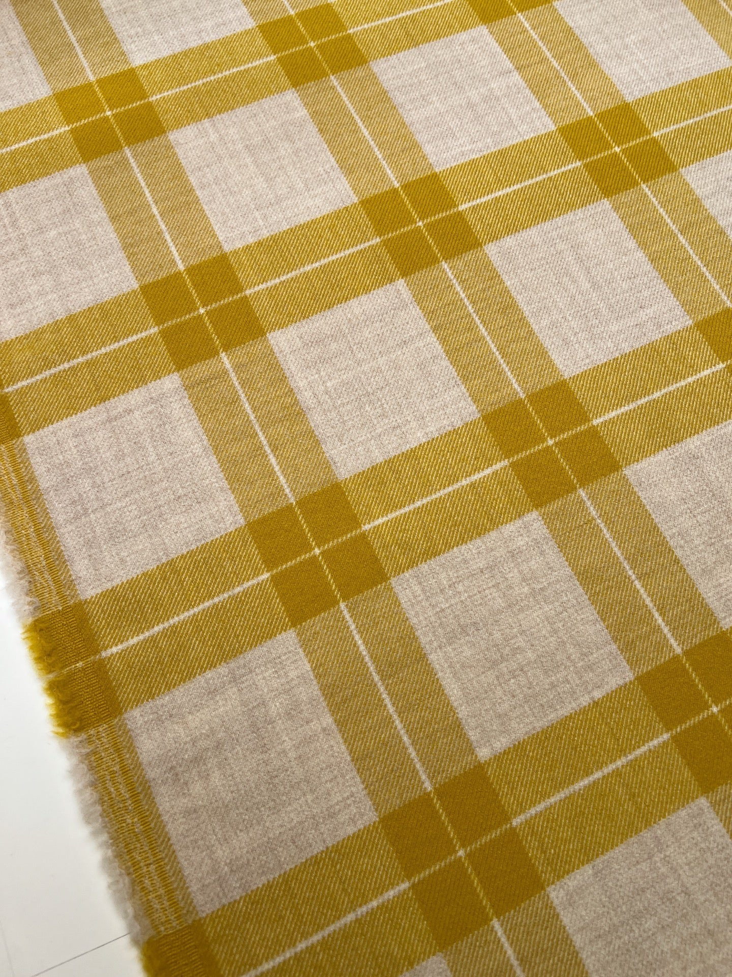 Image of Italian wool and alpaca fabric in a plaid pattern in mustard yellow tones – available online at Charlotte's Fabrics