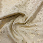 Attēls ar Kanvas audums - zelta lapiņas uz gaiša fona 175 g/m² – pieejams Šarlotes audumi