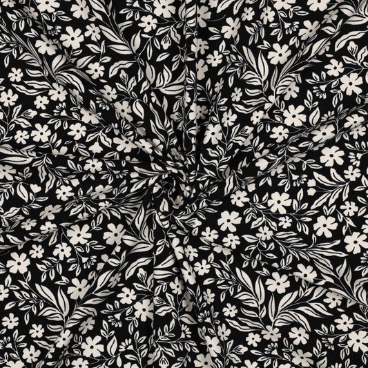 Attēls ar Kokvilnas trikotāža - balti ziedi uz melna 200 g/m² – pieejams Šarlotes audumi
