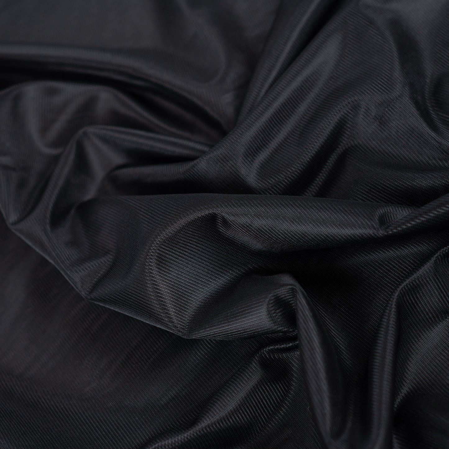 Image du tissu de doublure en maille noir – disponible en ligne chez Šarlotes audumi