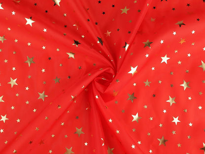Bild eines dekorativen Weihnachtsstoffs mit goldenen Sternen – online erhältlich bei Šarlotes audumi